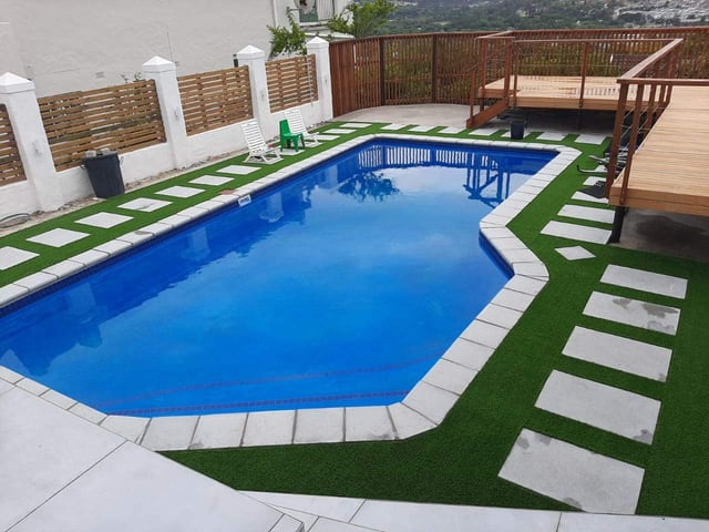 Free-form pool with turf lawn and decking, Cape Town